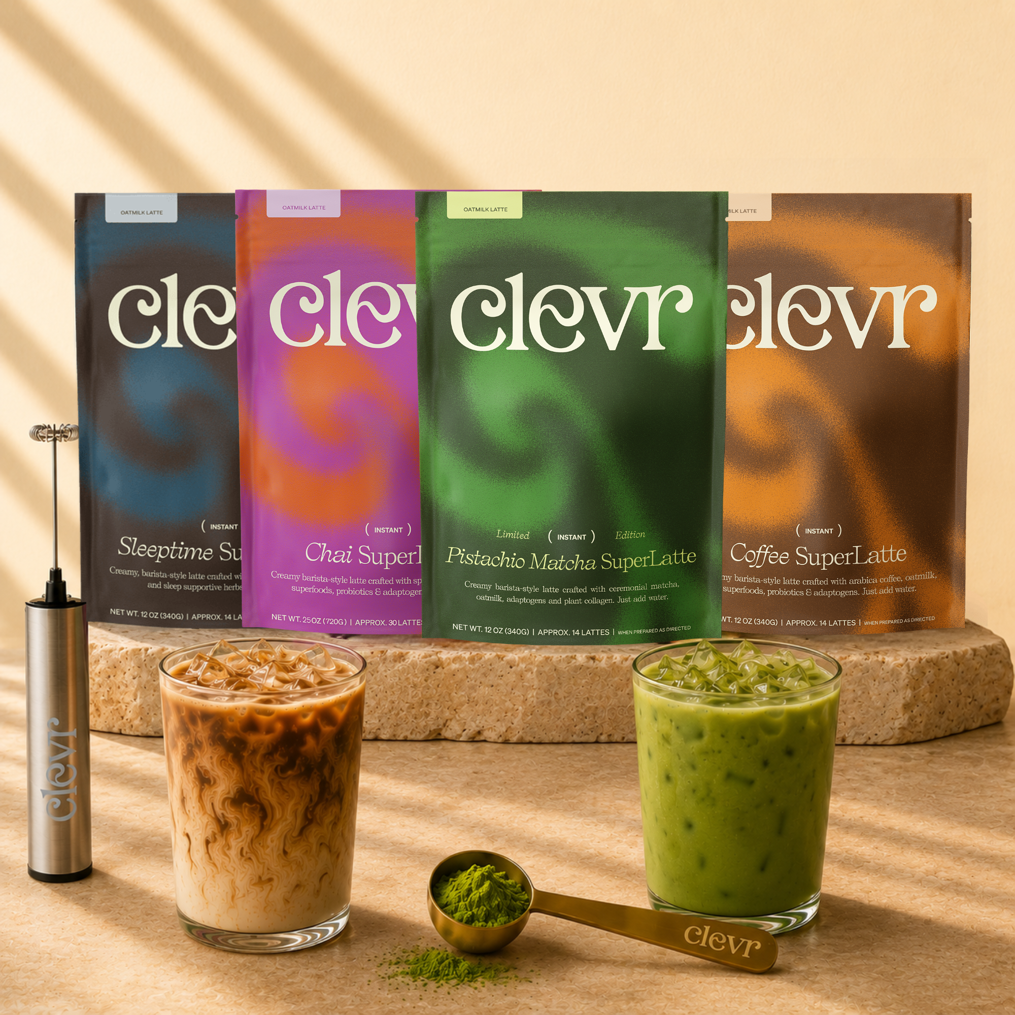 4 bags of clevr lattes displayed with 2 glasses of iced lattes and a spoon with matcha