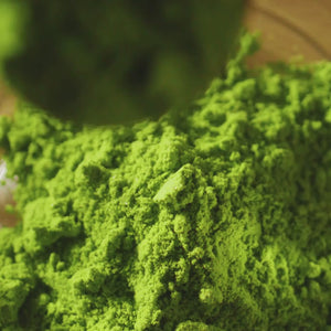 video of matcha powder being mixed into a latte drink