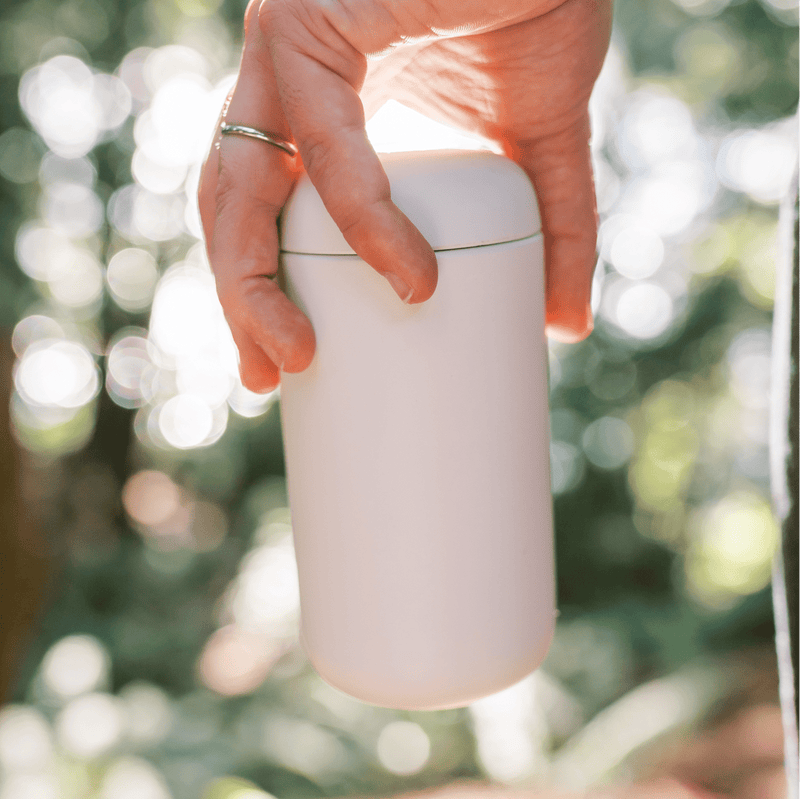 Hand holding Clevr thermos outside